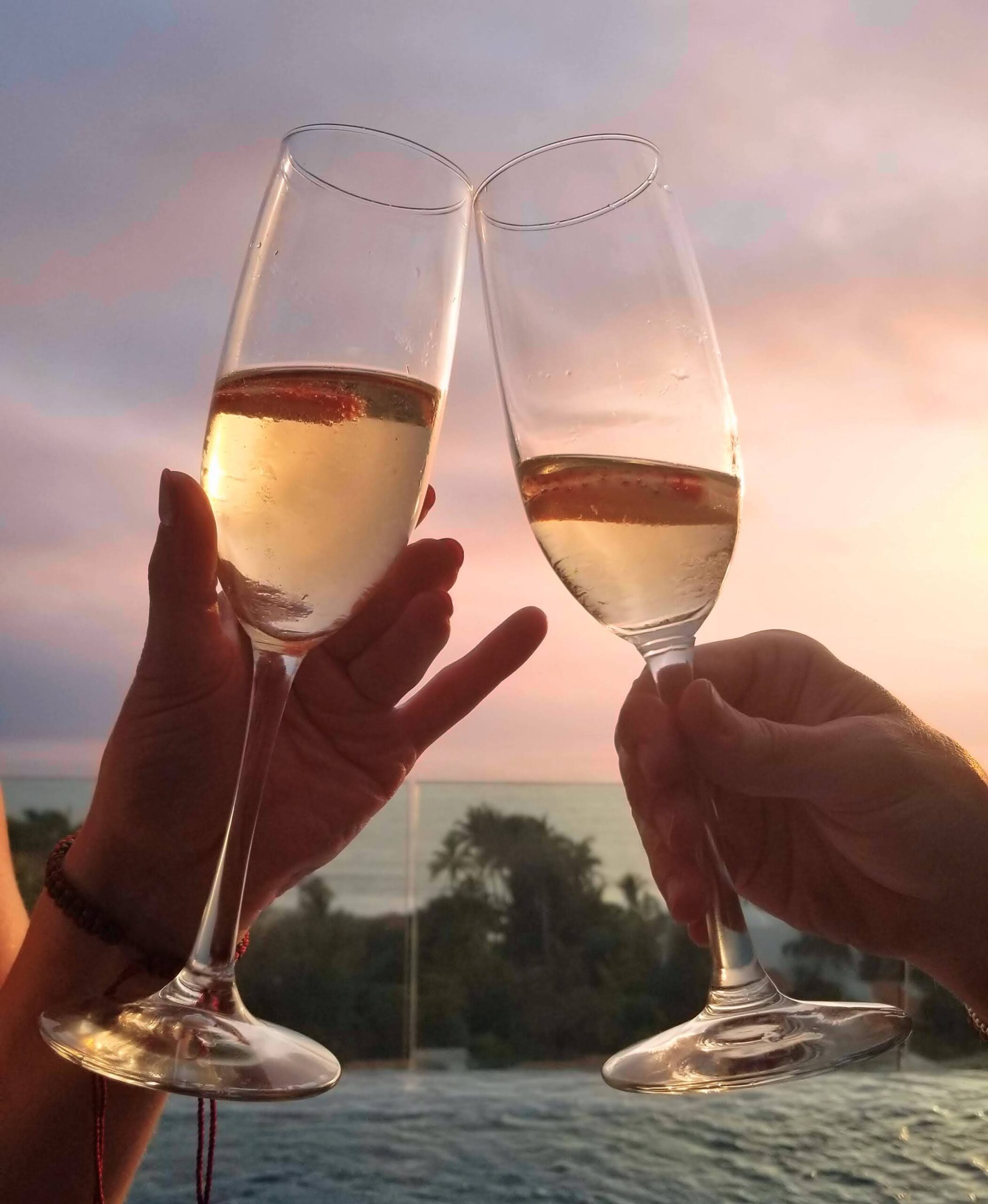 champagne cheers at sunset over water