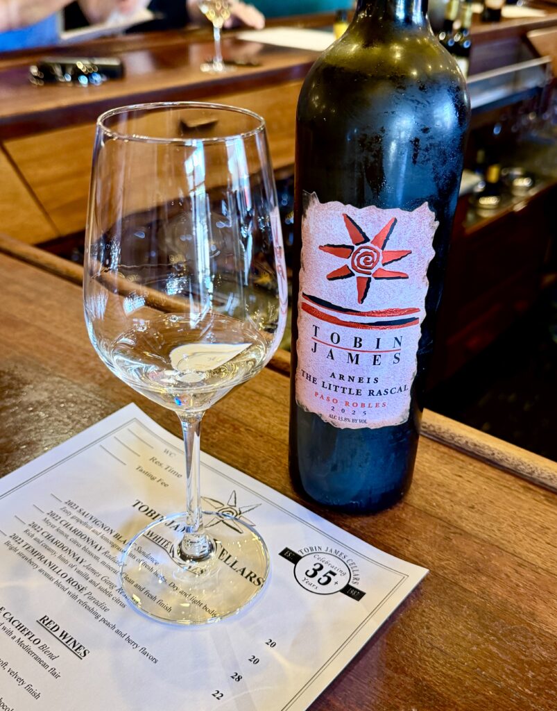 tobin james winery red wine bottle and tasting list next to a glass at the mahogany tasting bar in paso robles